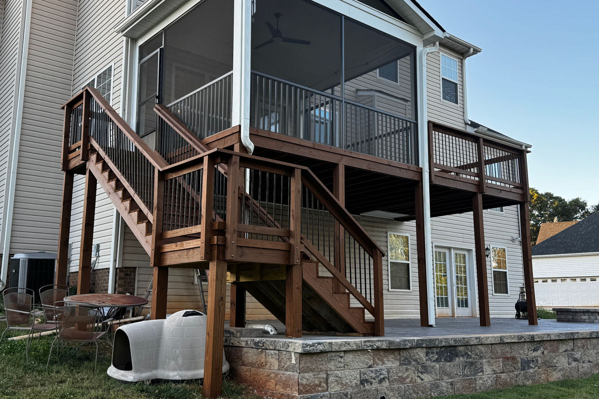 Stained elevated deck with screened porch and stairs in the Upstate