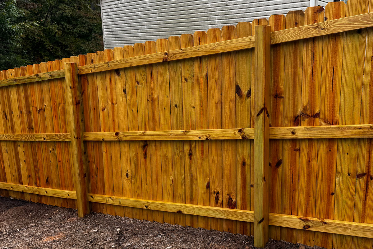 Golden oil-stained privacy fence in the Upstate
